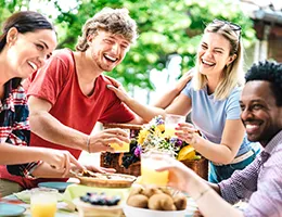 group of young adults eating at a restaurant